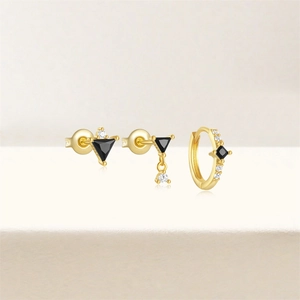 Macro shot of 925 silver gold-plated flower earrings set with black and white diamonds
