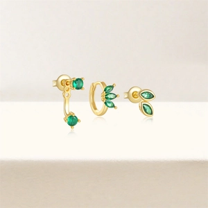 Detailed shot of S925 silver four-petal flower earrings with green marquise gems