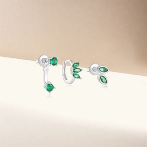 Close-up of S925 silver flower stud earrings set with green emerald gemstones