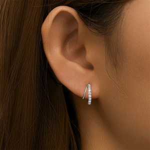 Close-up of double hoop earrings in S925 silver with cubic zirconia inlays on a model