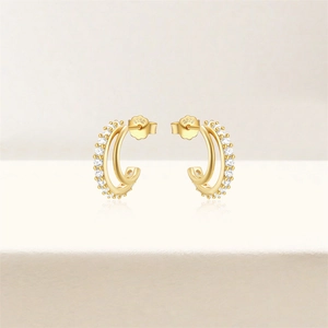 Detailed macro view of S925 sterling silver gold double hoop earrings with cubic zirconia