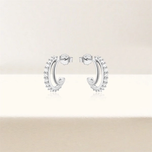 Detail of S925 silver double-row C-shaped hoop earrings with sparkling zircon stones
