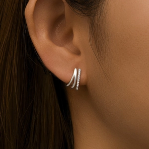 Macro shot of silver triple-layered ear cuff with sparkling zircon inlay for women