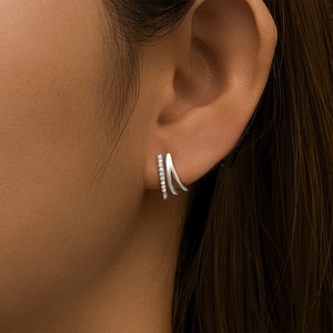 Close-up of S925 sterling silver triple-layered curved earrings with paved zircons