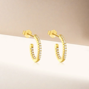 Macro view of gold-plated S925 sterling silver hoop earrings with white zircon accents