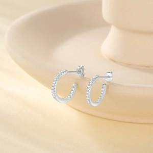 Close-up of S925 sterling silver C-shaped earrings with white zircon pavé setting
