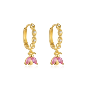 Close-up of golden bee earrings with pink marquise wings and sparkling zircons