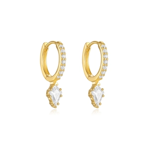 Macro shot of gold hoop earrings with kite-cut stones and sparkling zircon pavé
