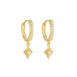 Macro shot of gold diamond-shaped earrings featuring a large center cubic zirconia stone
