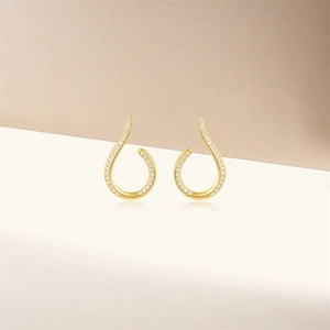 Close-up of gold S925 silver hoop earrings with pave-set white cubic zirconia stones