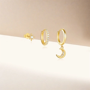 Detail of S925 sterling silver star and moon earrings set with gold finish and zirconia