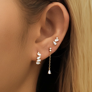 Macro shot of 925 silver gold-plated earring set with pear-cut cubic zirconia crystals