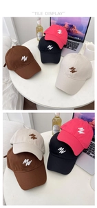 Flat lay of cotton baseball caps with MW embroidery in red, black, brown, and beige