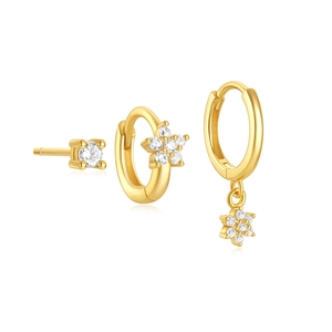 Detailed close-up of gold s925 silver flower and star stud earring set with zircons