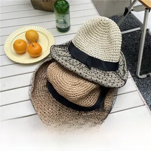 Close-up of foldable mesh sun hats with dot patterns and elegant bow ribbons