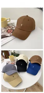 Close-up of the fine embroidery detail on various colors of twill cotton baseball caps