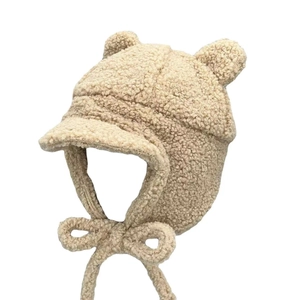 Warm beige lamb wool trapper hat with cute bear ears and protective ear flaps for winter