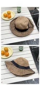 Detailed top and side view of a beige straw hat with black ribbon and polka dot mesh