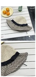 Detail of sun hat showing polka dot mesh trim and elegant black ribbon bow