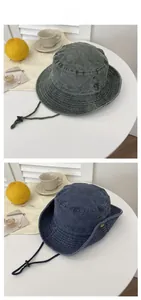 Detail of vintage washed bucket hats with metal eyelets and adjustable chin straps