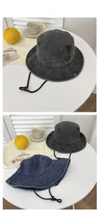 Detail view of denim bucket hat with metal eyelets and adjustable windproof rope strap
