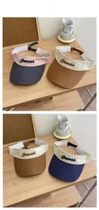 Detailed tile display of various color-blocked open top sun visors with Greenich embroidery