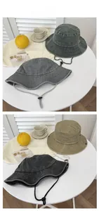 Detail of vintage washed cotton bucket hat with adjustable chin strap and metal eyelets