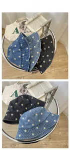 Detailed tile display of daisy embroidery on denim bucket hats in multiple colors