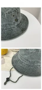 Detail of wide brim bucket hat showing reinforced stitching and adjustable drawstring cord
