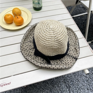 Straw sun hat with grey polka dot mesh and black ribbon bow for summer outdoor use