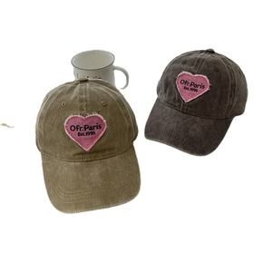 Vintage washed cotton baseball caps in brown and black with pink heart embroidery