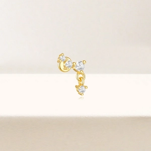 Detail of s925 silver lotus stud earring in gold finish with sparkling zircon stones