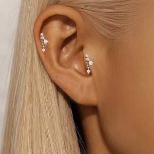 Detail of S925 sterling silver lotus cartilage piercing with sparkling cubic zirconia