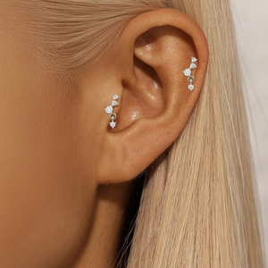 Close-up of S925 sterling silver lotus cartilage earring with sparkling zircon studs