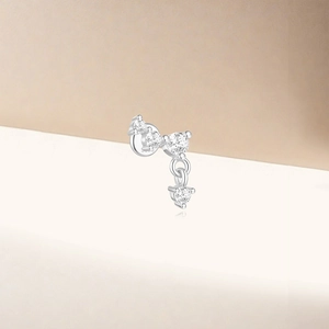 Macro shot of silver lotus stud earring with sparkling cubic zirconia on light background