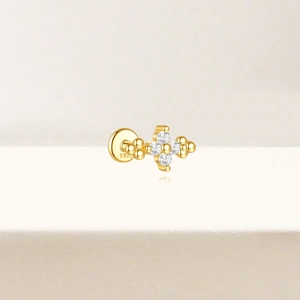 Macro detail of S925 sterling silver stamp on golden flower stud earring with zircons