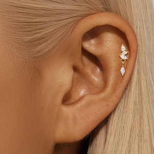 Macro detail of S925 sterling silver lotus piercing earring with marquise zirconia
