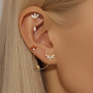 Detailed shot of S925 silver ear cuff with marquise zircon and delicate gold chain