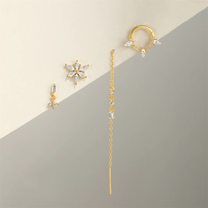 Detail of four-piece set S925 silver gold-plated earrings with cubic zirconia