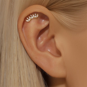 Close-up of golden crown stud earring featuring sparkling marquise cut cubic zirconia