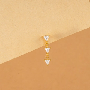 Detail of three-tier golden clover stud earring with triangular cubic zirconia stones
