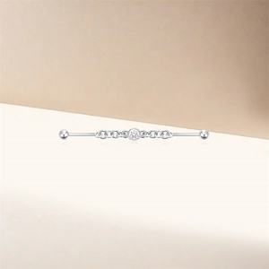 Macro detail of s925 silver industrial barbell featuring star moon chain and zircon gem