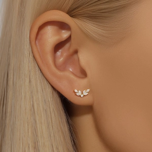 Macro detail of gold S925 silver stud earring with leaf-shaped marquise cubic zirconia