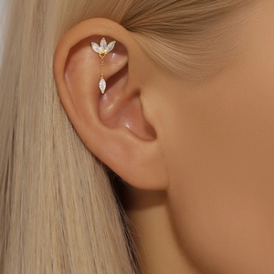 Close-up of gold S925 silver ear cuff with marquise zircon stones and leaf pendant
