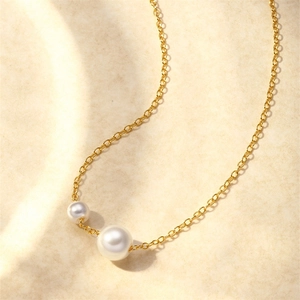 Detalle del colgante de doble perla deslizante en cadena dorada de plata S925