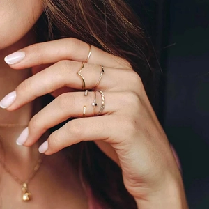 Close-up of a 925 sterling silver minimalist gold ring set with stacked geometric designs