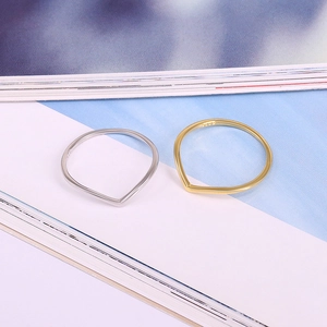 Detailed view of S925 sterling silver stamp on minimalist V-shaped wedding bands