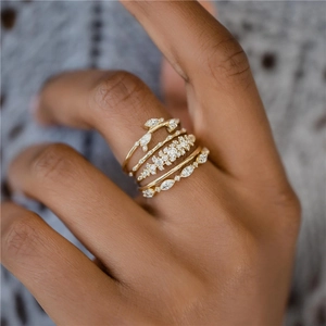 Close-up of elegant gold ring set for women with sparkling white zircon leaf clusters