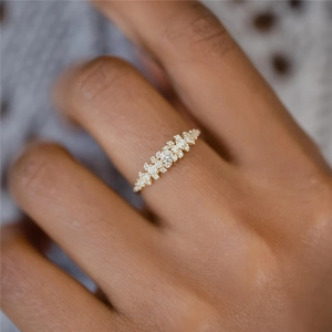Macro view of a 925 silver ring with irregular pavé diamonds worn on a finger