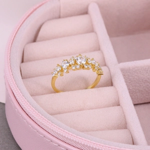 Detailed shot of a gold-plated multi-layer crystal ring inside a pink velvet jewelry box